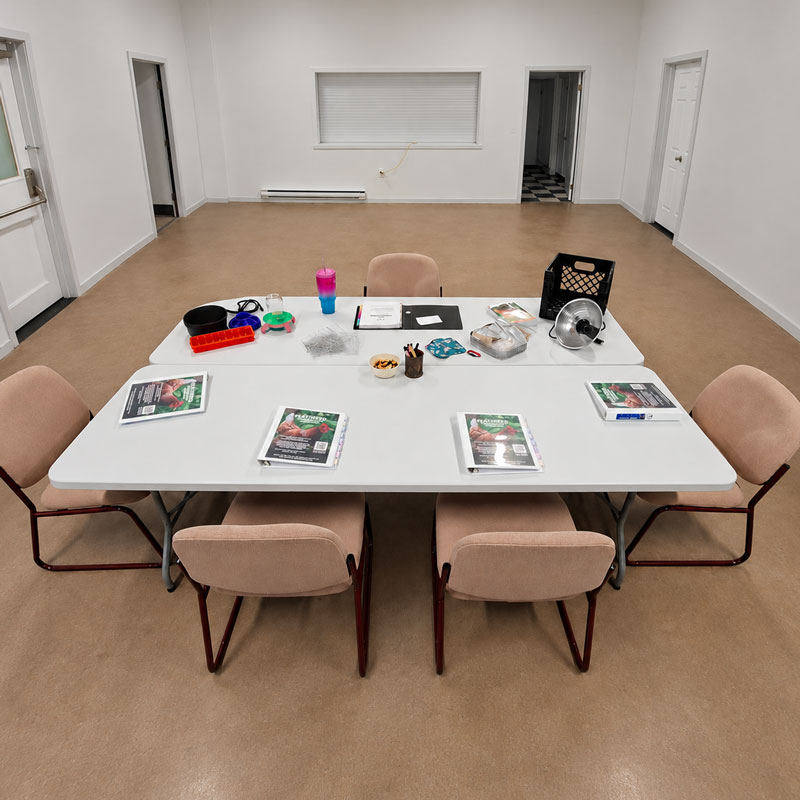 Chicken-keeping workshop materials arranged around a classroom table.